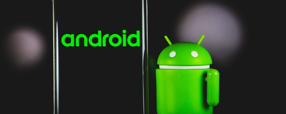 Image of the Android logo beside a smartphone against a black background.