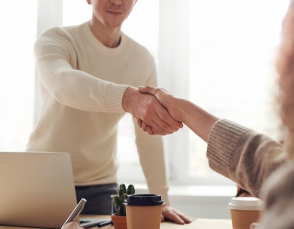 Photo of a handshake over a desk