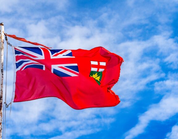 Ontario flag pictured against a blue sky