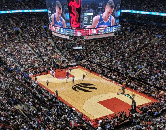 Photo of the Raptors NBA logo on the court of Scotiabank arena