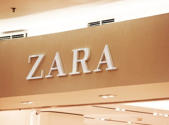Photograph of the "ZARA" trademark in a sign above a Zara storefront.
