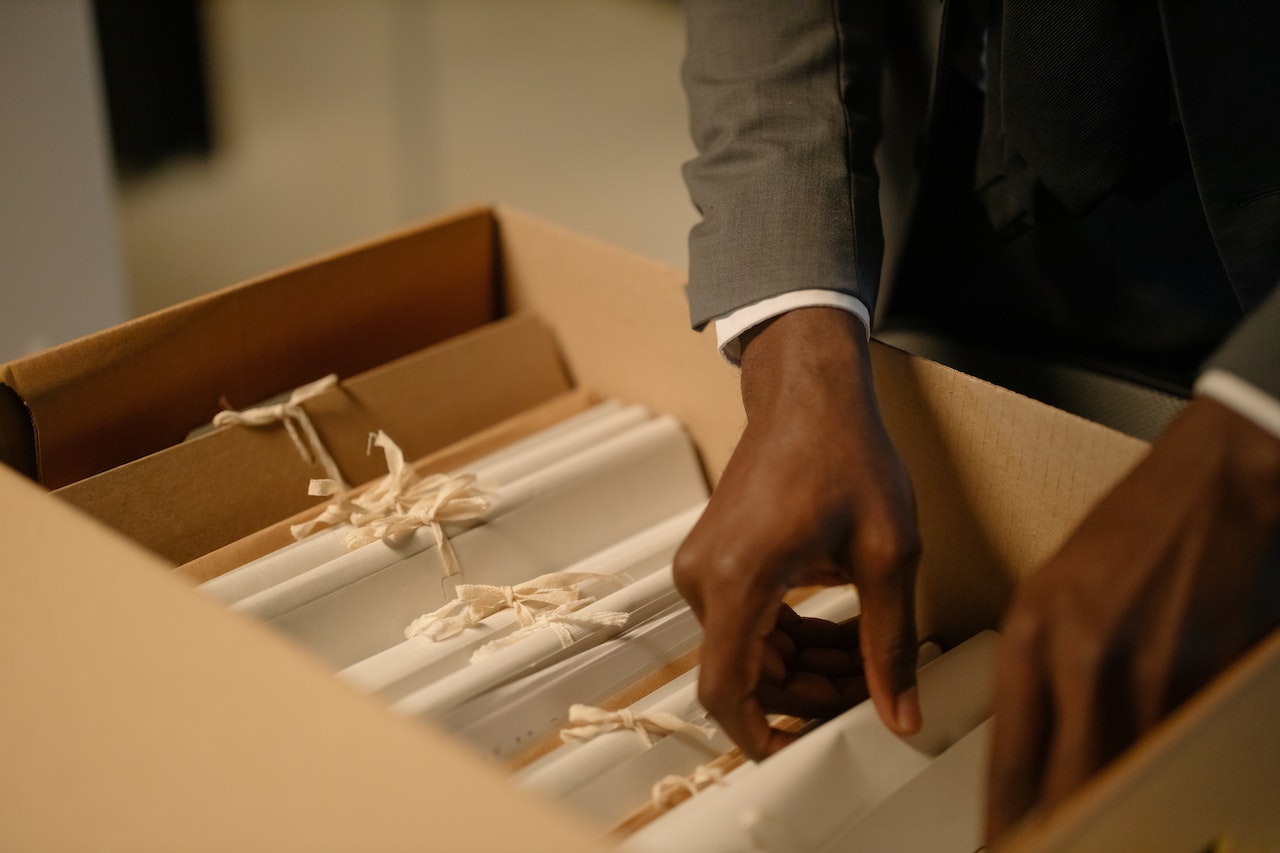 A banker's box filled with files containing evidence