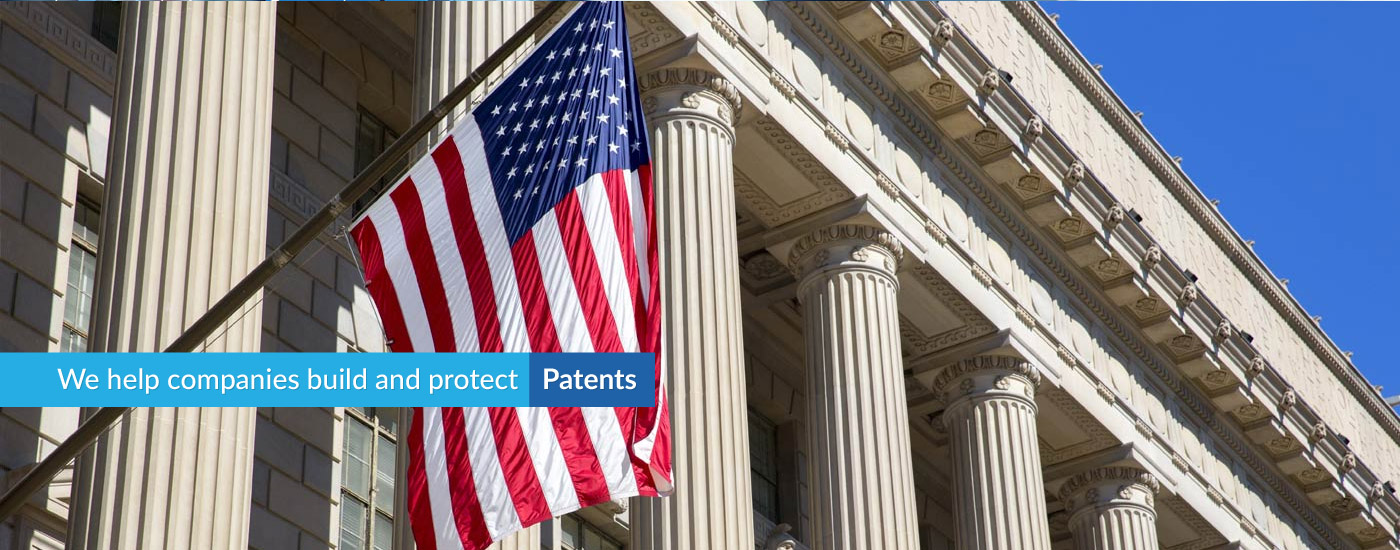 Photograph of USA flag with text overlay reading "We help companies build and protect Patents"