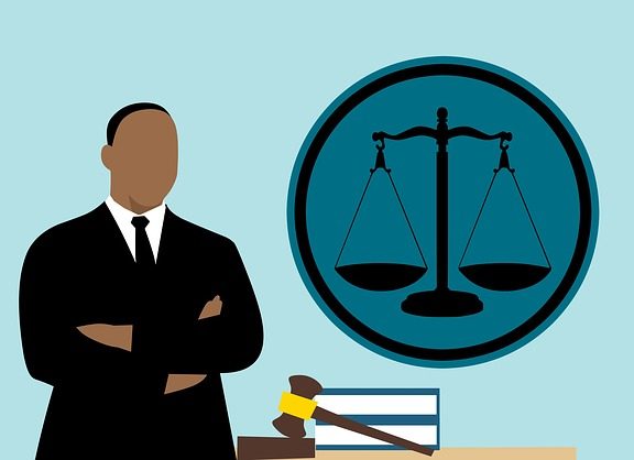 Cartoon of a lawyer, gavel, and scales of justice