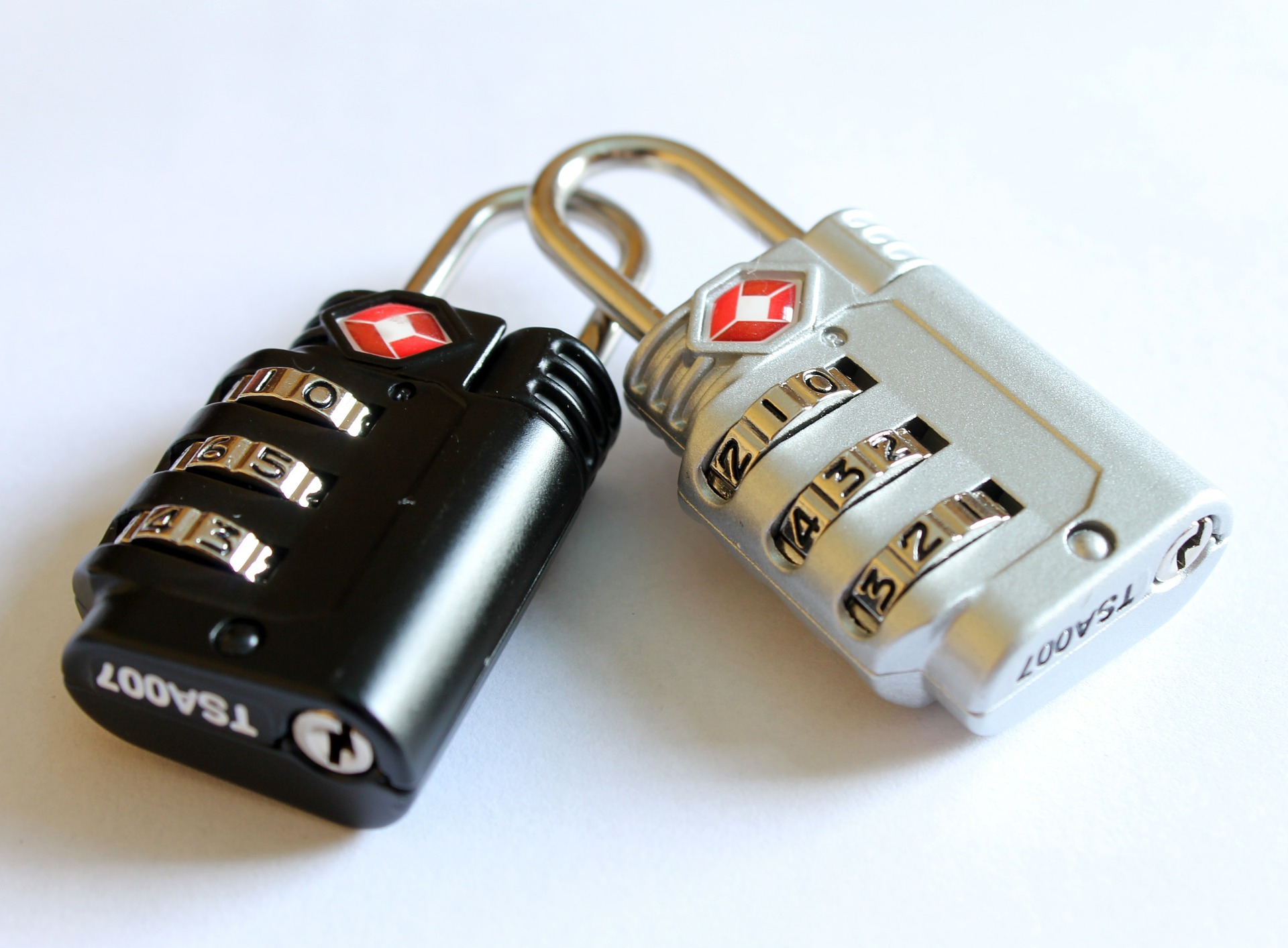 A photo of two TSA-approved luggage locks bearing the red Travel Sentry logo. 