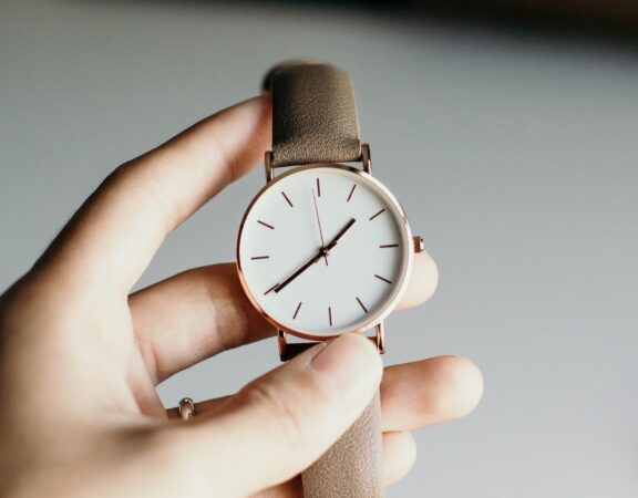 Photograph of a watch in someone's hand.