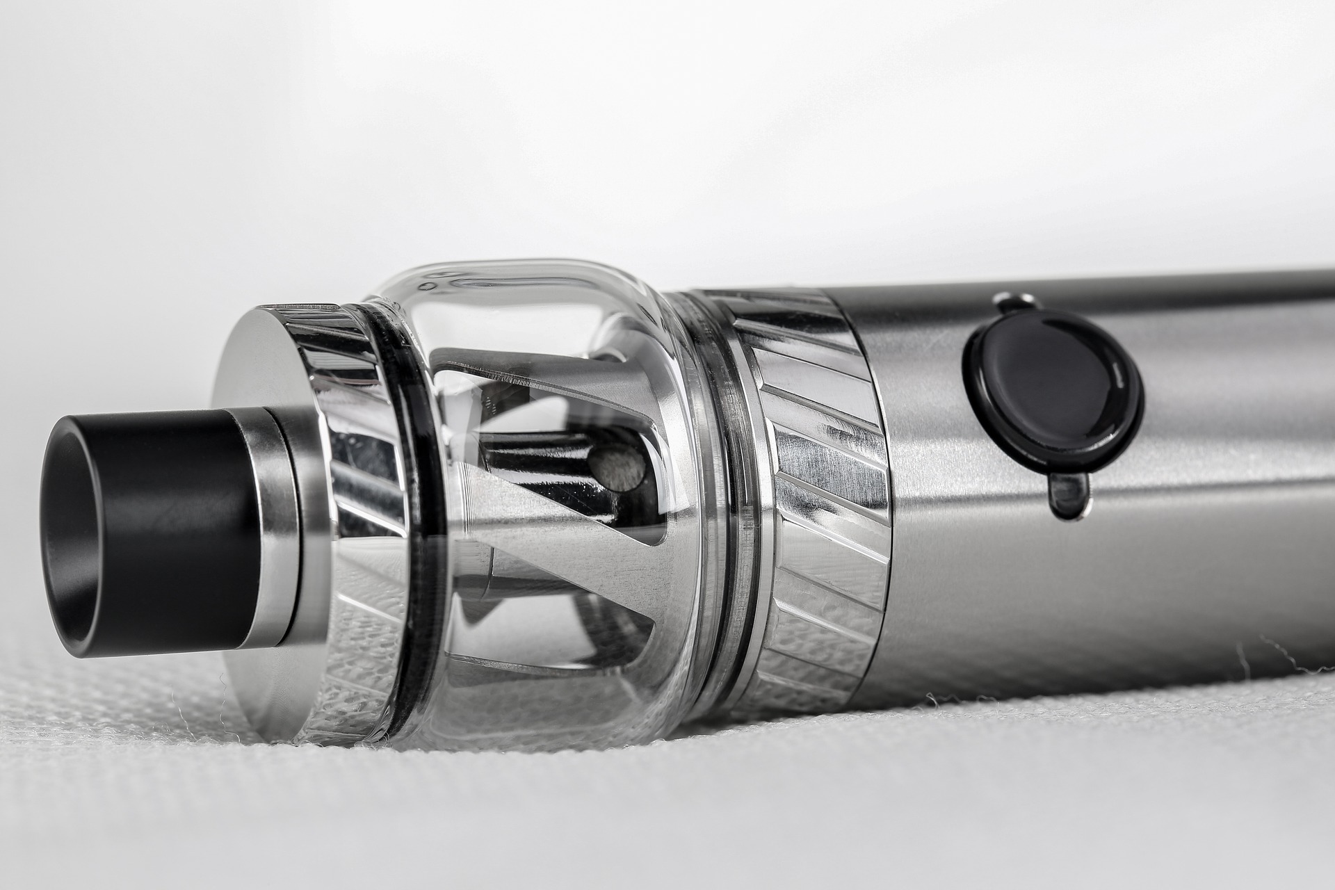 A close-up photograph of a metal vaporizer or vape-pen